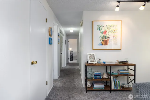 a view of a hallway with paintings on the wall