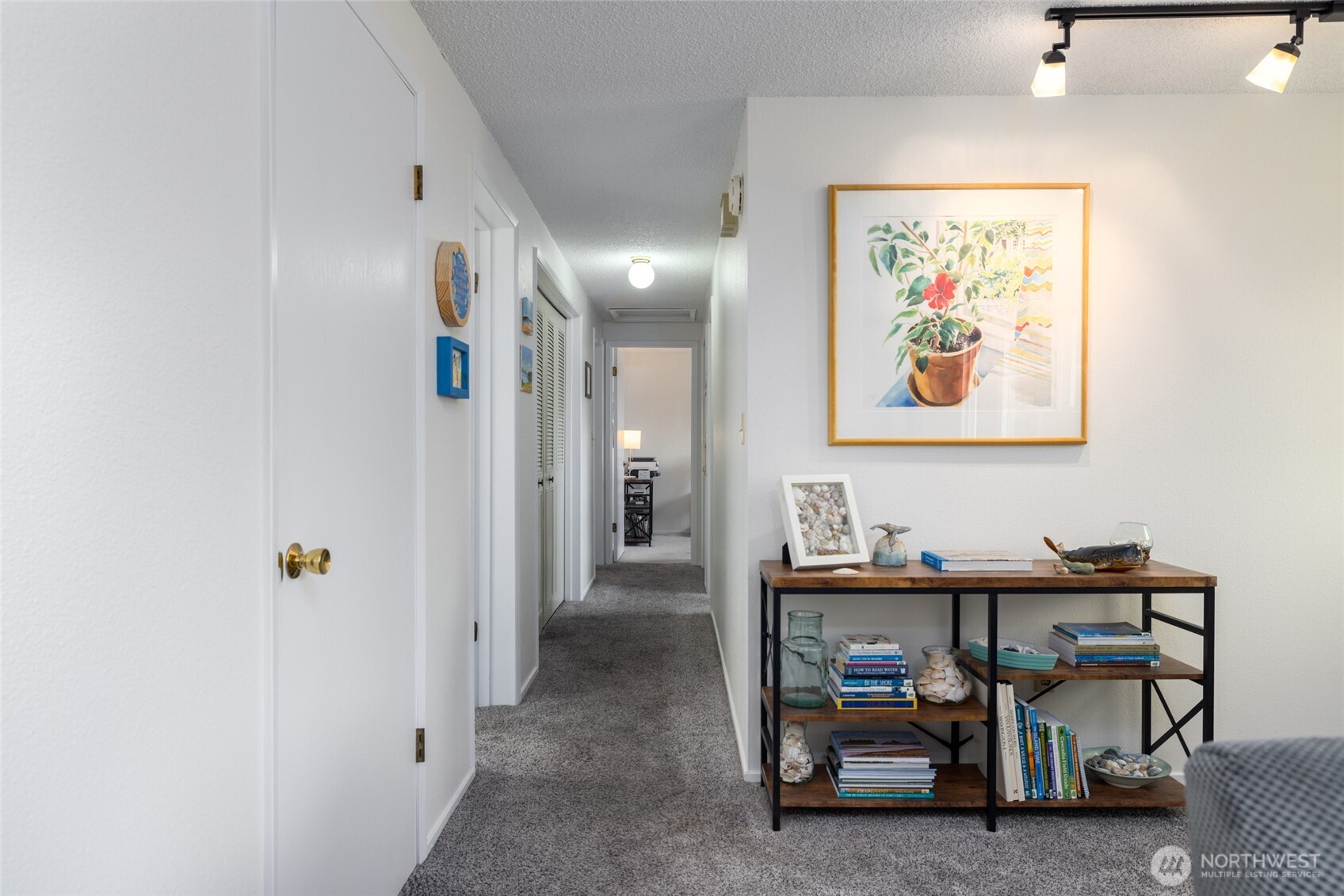 494 Colville Way La Conner, WA 98257 - Photo 16 of 39 a view of a hallway with paintings on the wall