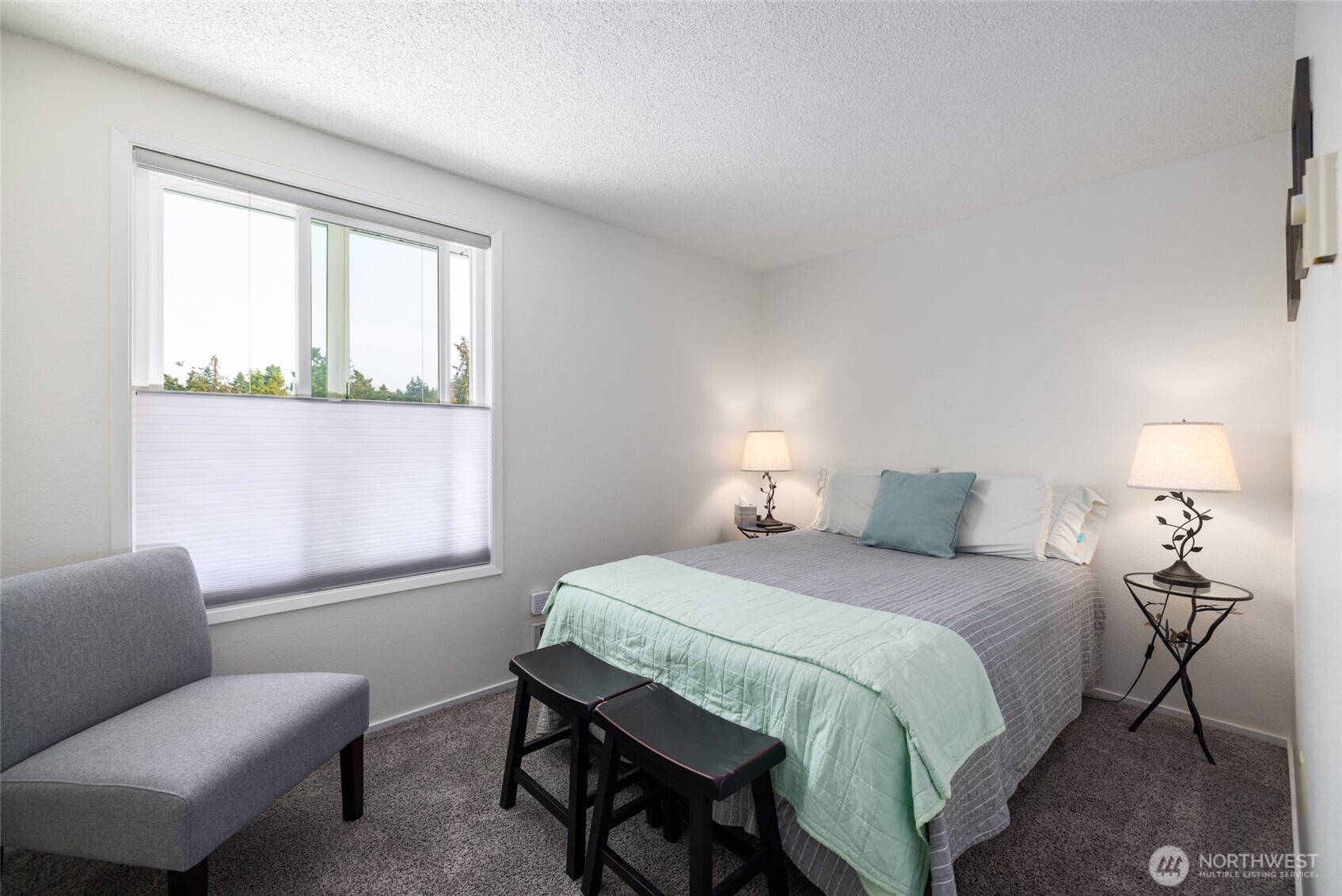 494 Colville Way La Conner, WA 98257 - Photo 18 of 39 a bedroom with a bed and a window