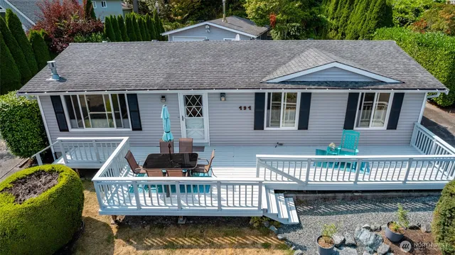 a view of a house with a deck and furniture
