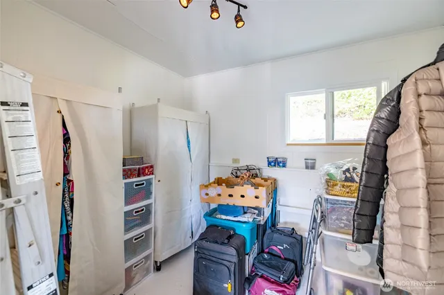 a bedroom with furniture and a book shelf