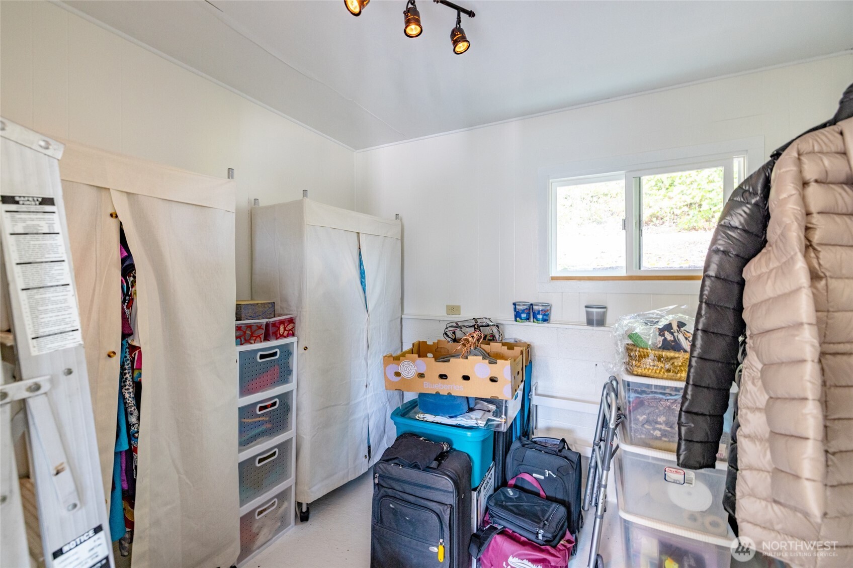 494 Colville Way La Conner, WA 98257 - Photo 32 of 39 a bedroom with furniture and a book shelf