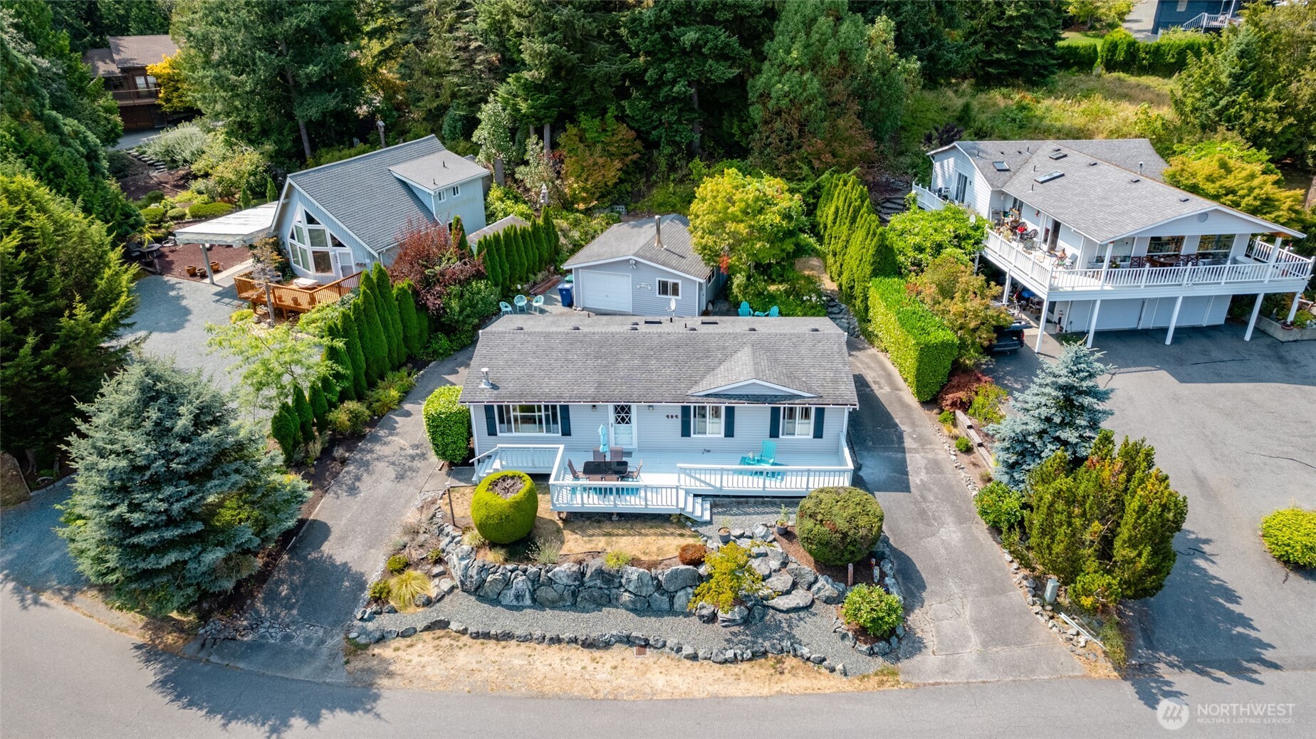 494 Colville Way La Conner, WA 98257 - Photo 37 of 39 an aerial view of a house with a swimming pool a yard and a garden