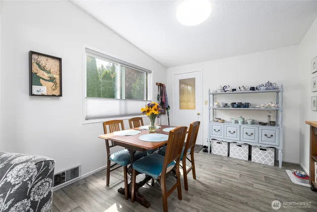 a view of a dining room with furniture window and wooden floor
