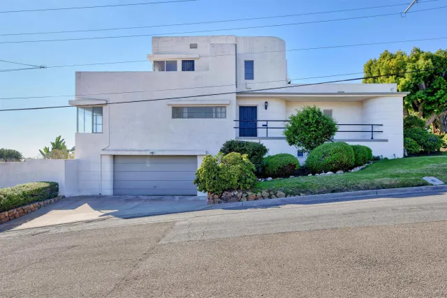 a front view of a house with a yard and a garage