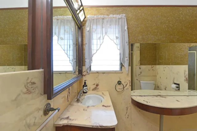 a bathroom with a tub sink and mirror