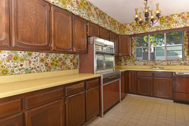 a kitchen with stainless steel appliances granite countertop wooden cabinets a sink and dishwasher