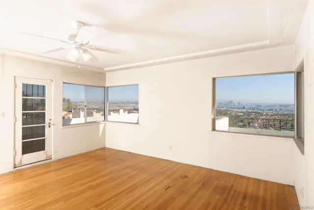 a view of a kitchen with wooden floor and a ceiling fan