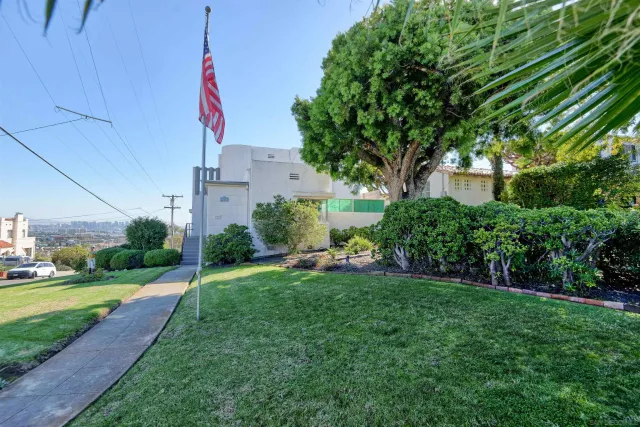 a view of a chair and table in backyard of the house
