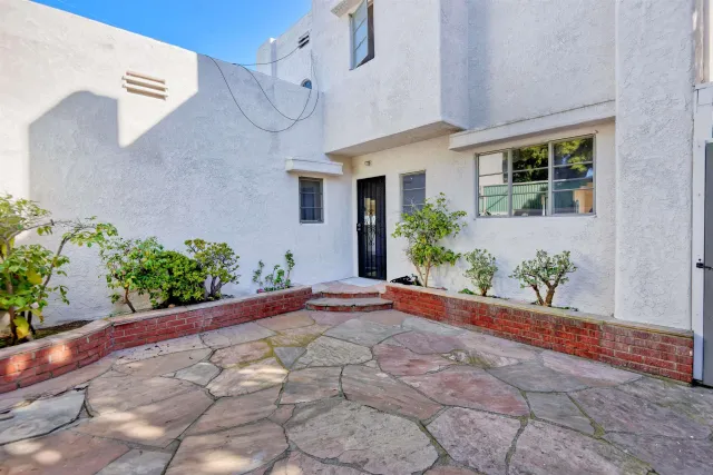 a view of a house with potted plants
