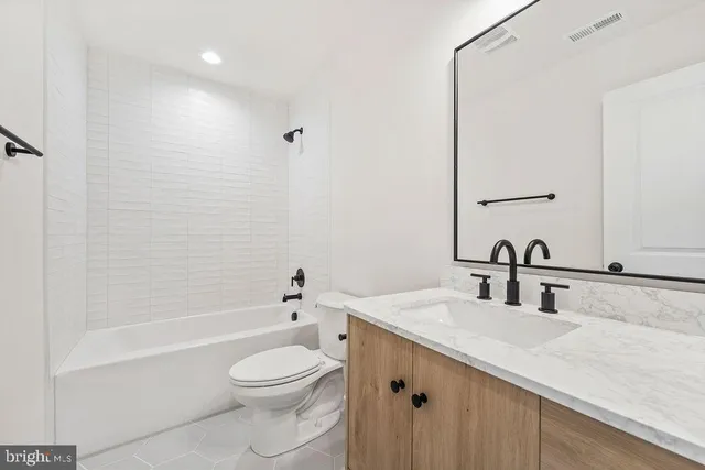 an empty room with windows and ceiling fan