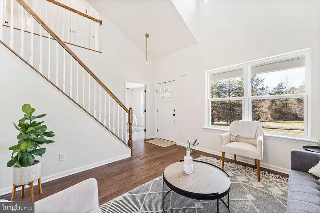 a living room with furniture potted plant and a window