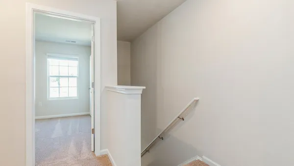 a view of a hallway with a white walls