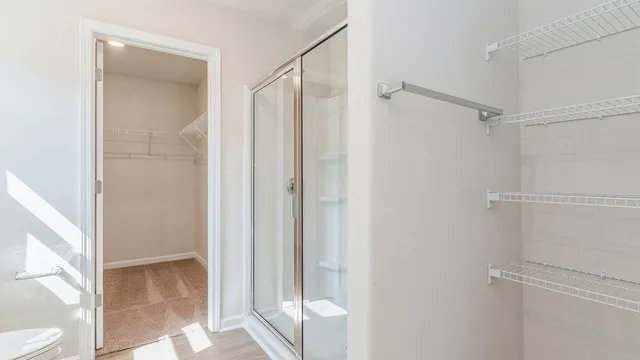 a view of bathroom with a shower and a toilet