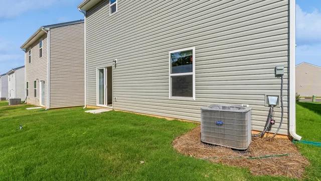 a view of a backyard with plants and a grill