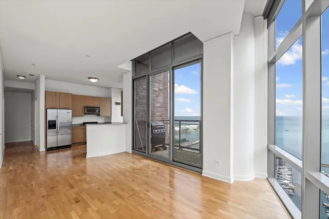 a view of kitchen with furniture and refrigerator