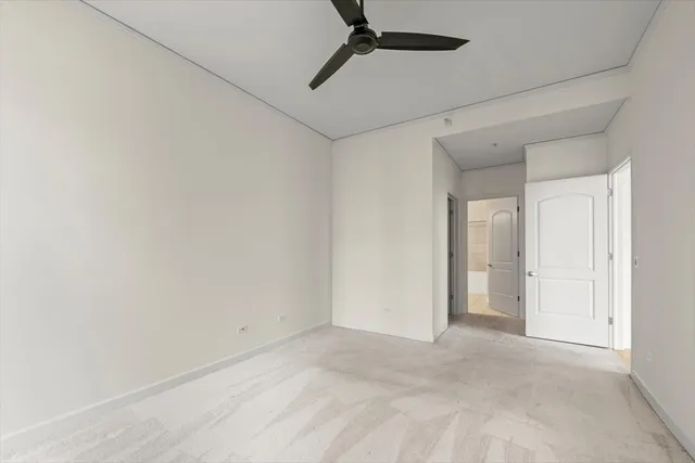 a view of a room with a ceiling fan