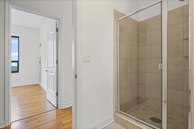 a bathroom with a glass shower door
