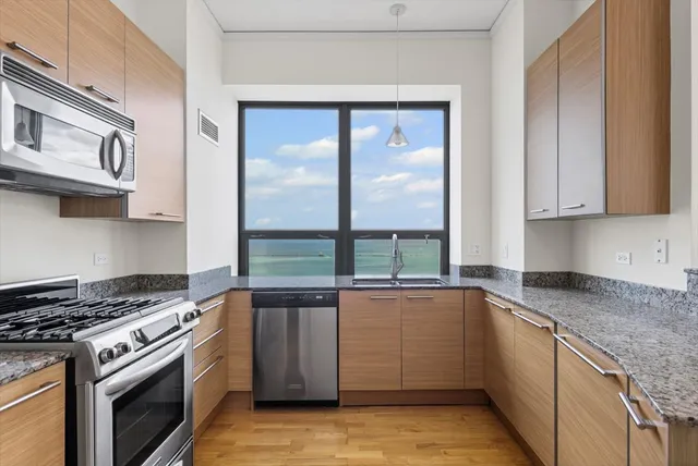 a kitchen with a sink stove and cabinets
