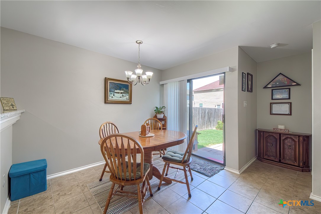 5709 Ping Way Schertz, TX 78108 - Photo 11 of 28 a view of a dining room with furniture window and wooden floor