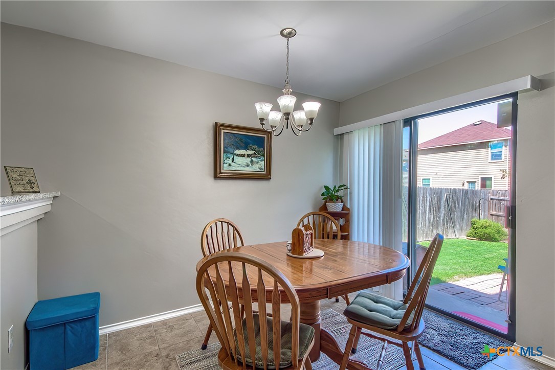 5709 Ping Way Schertz, TX 78108 - Photo 13 of 28 a view of a dining room with furniture window and wooden floor