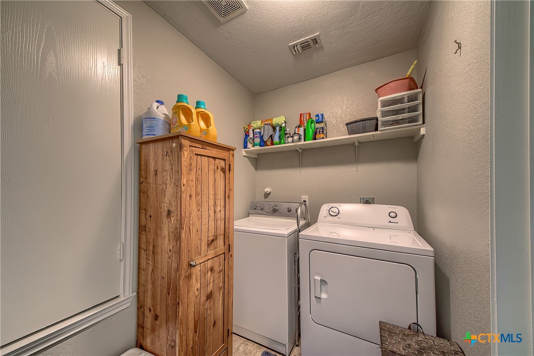5709 Ping Way Schertz, TX 78108 - Photo 15 of 28 a utility room with dryer and washer