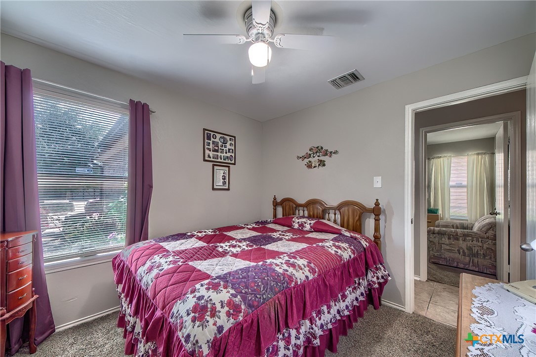5709 Ping Way Schertz, TX 78108 - Photo 18 of 28 a bed sitting in a bedroom next to a window
