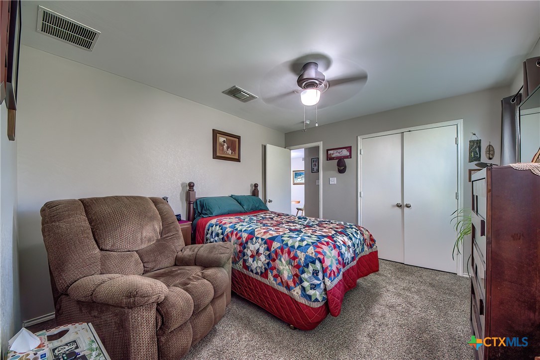 5709 Ping Way Schertz, TX 78108 - Photo 24 of 28 a bedroom with a bed couch and a ceiling fan