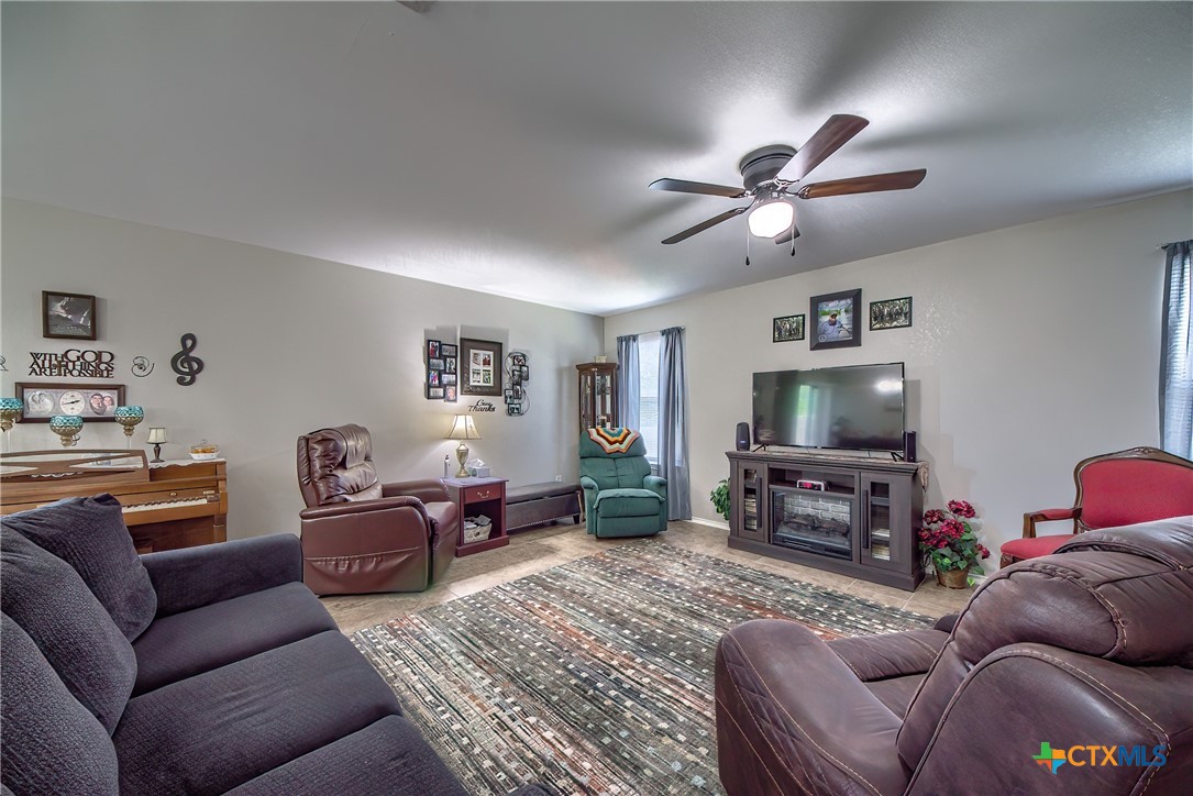 5709 Ping Way Schertz, TX 78108 - Photo 7 of 28 a living room with furniture a flat screen tv and a window