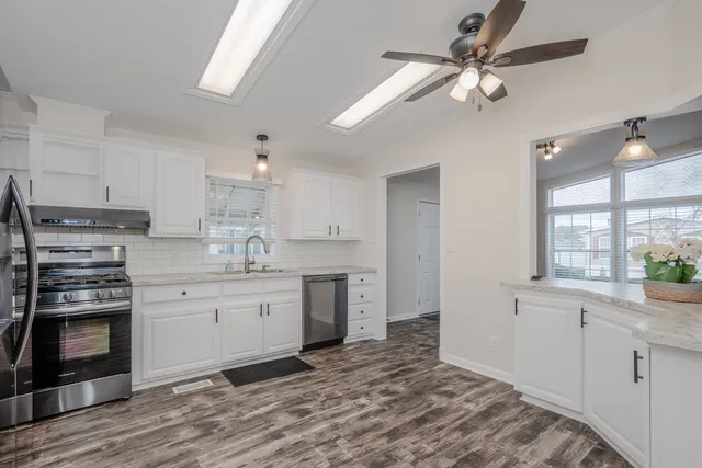 a kitchen with a stove a sink and a refrigerator