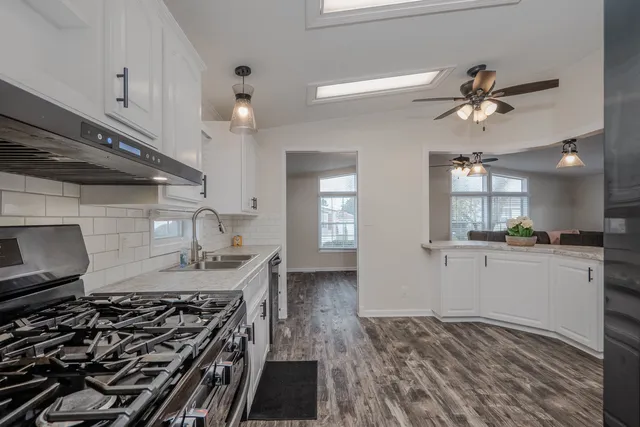 a kitchen with a stove and a wooden floors