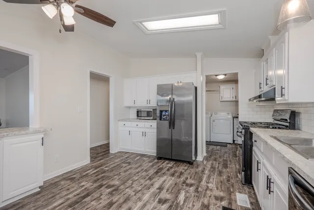 a kitchen with a refrigerator and a sink