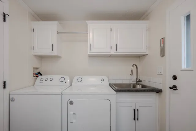 a view of kitchen with sink and cabinets