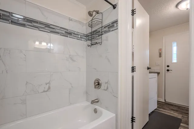 a bathroom with a bathtub and a shower