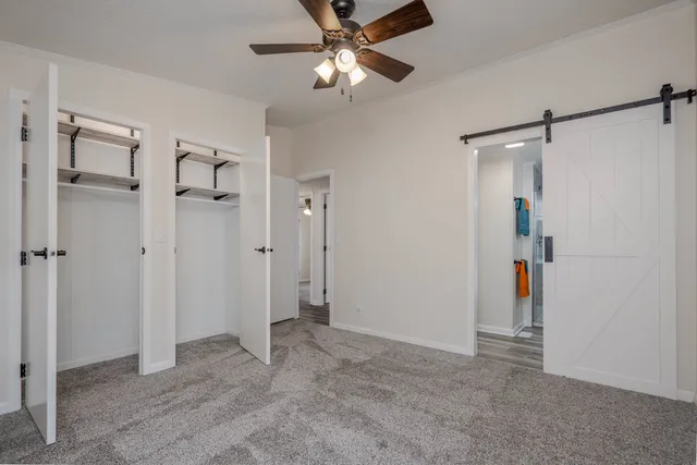 a view of empty room with ceiling fan