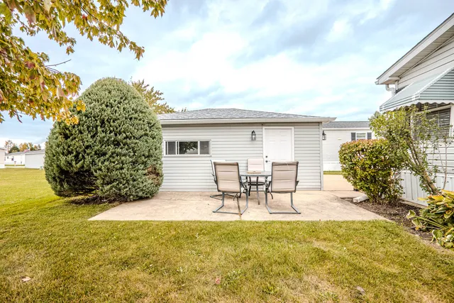 a view of a chairs and table in backyard