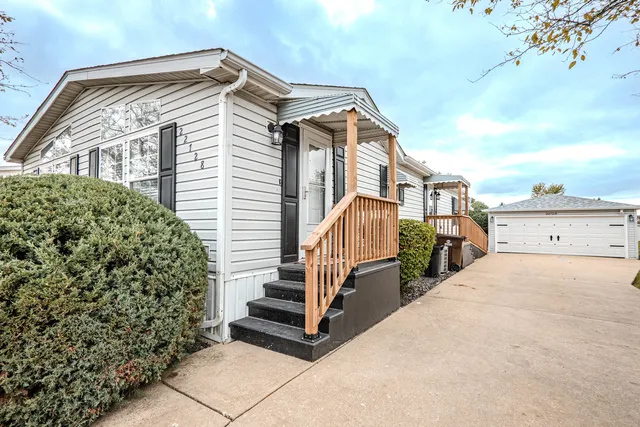 a view of a house with backyard and deck