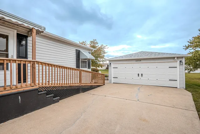 a view of a house with a wooden fence