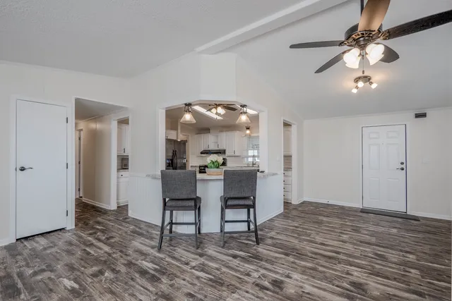 a view of a dining room with furniture and wooden floor