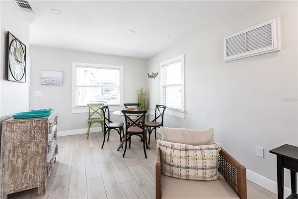 a dining room with furniture and wooden floor