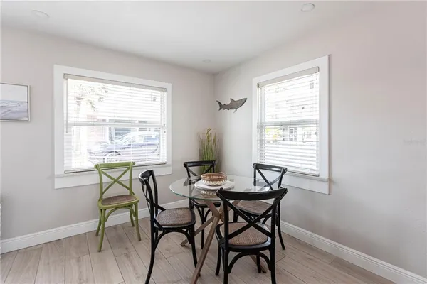 a view of a dining room with furniture and wooden floor