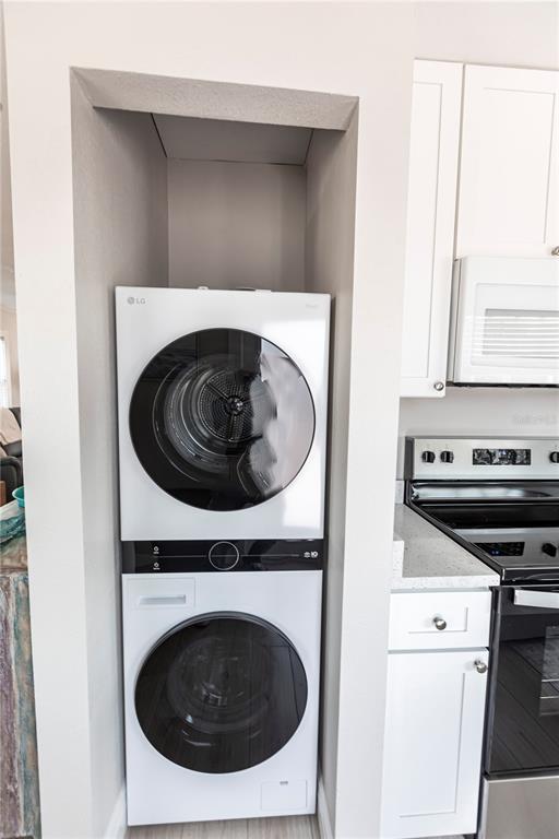 6020 Midnight Pass Road, Unit 56 Sarasota, FL 34242 - Photo 14 of 29 a utility room with dryer and washer