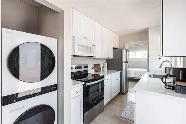 a kitchen with a stove top oven and refrigerator