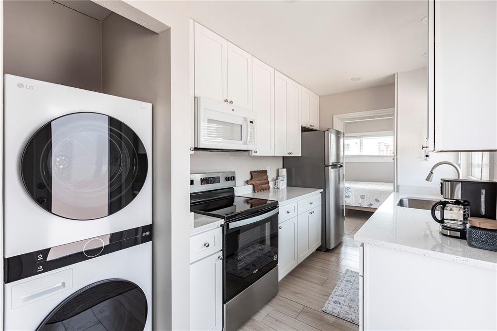 6020 Midnight Pass Road, Unit 56 Sarasota, FL 34242 - Photo 15 of 29 a kitchen with a stove top oven and refrigerator