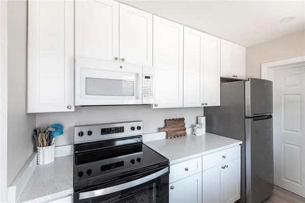 a kitchen with stainless steel appliances a stove a refrigerator and cabinets
