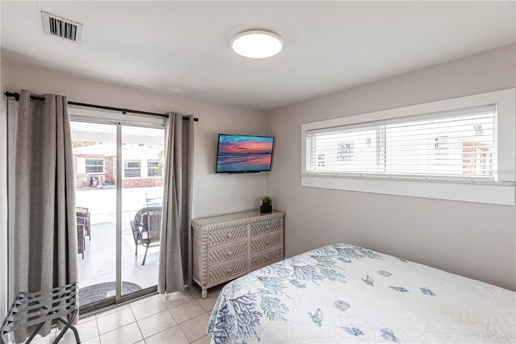 6020 Midnight Pass Road, Unit 56 Sarasota, FL 34242 - Photo 21 of 29 a bedroom with a bed and a window
