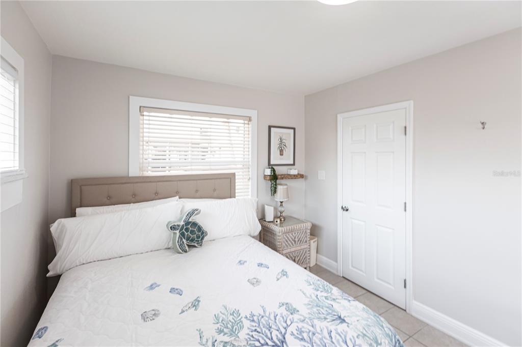 6020 Midnight Pass Road, Unit 56 Sarasota, FL 34242 - Photo 22 of 29 a bedroom with a bed and a window