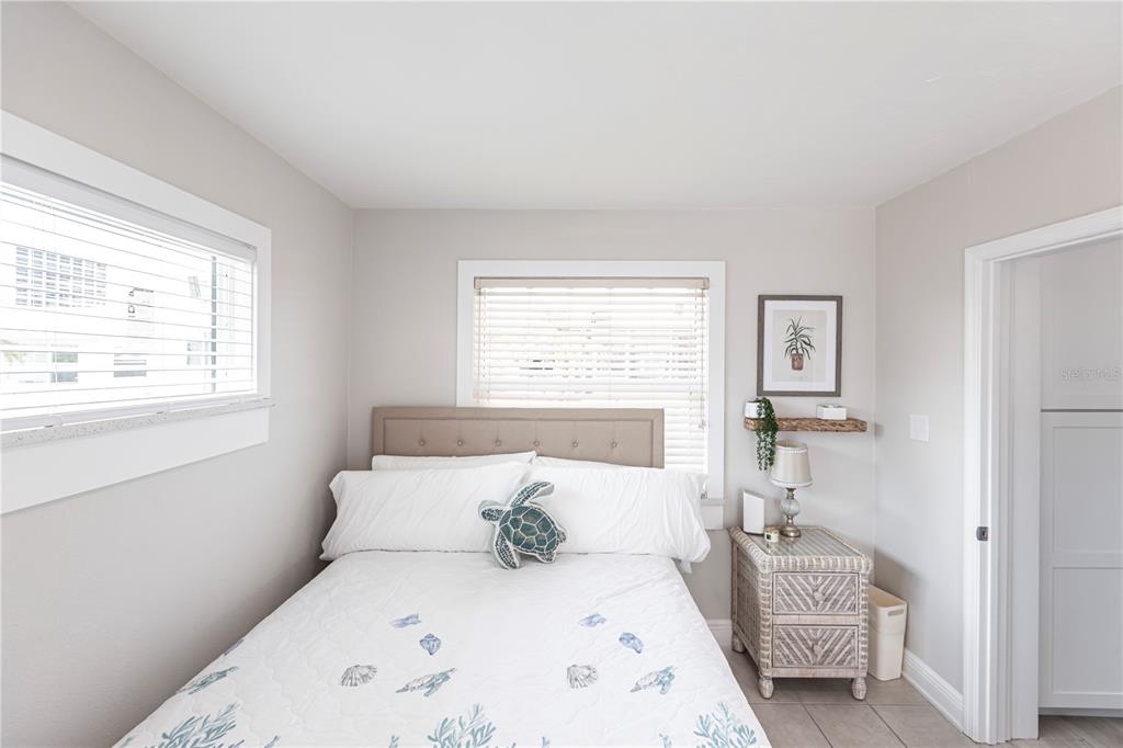 6020 Midnight Pass Road, Unit 56 Sarasota, FL 34242 - Photo 23 of 29 a bedroom with a bed and a window