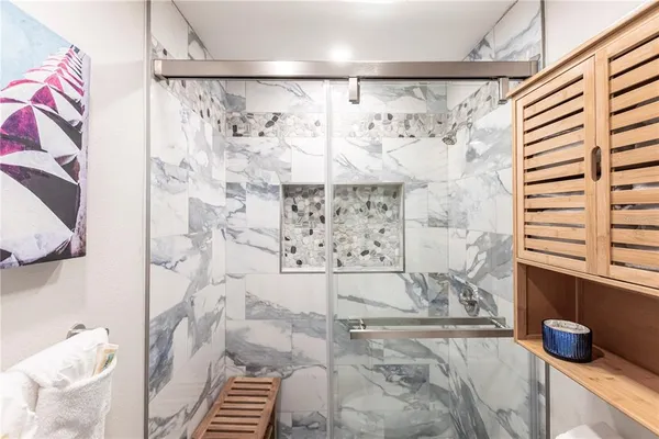 a bathroom with a shower and a sink