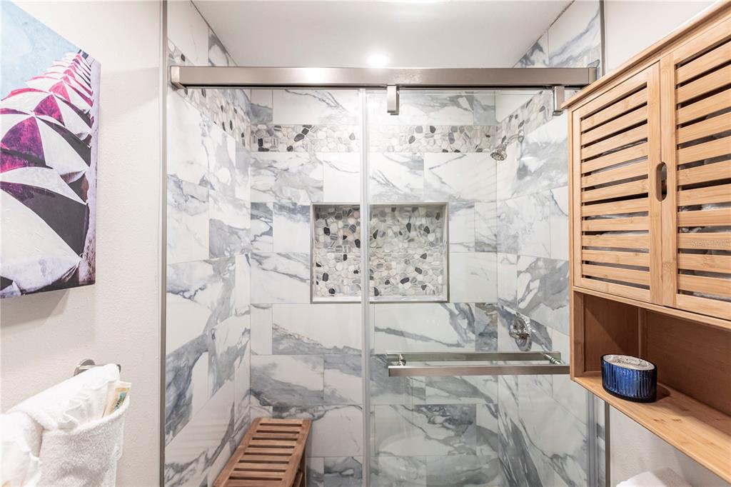 6020 Midnight Pass Road, Unit 56 Sarasota, FL 34242 - Photo 24 of 29 a bathroom with a shower and a sink